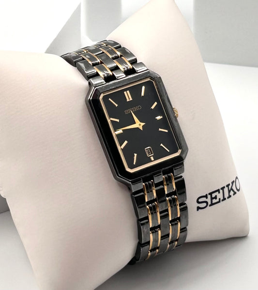 Vintage 1990 Seiko  black and gold tone watch 25mm size case, 6.5in size wrist bracelet.